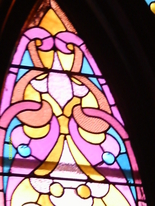 There are many shades of pinks and purples, mixed with amber and blue in this original stained glass window in The historic Olde North wedding Chapel, Richmond, Indiana