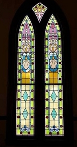 One of the stained glass window designs in the cathedral style windows of this historic Richmond, Indiana Wedding Chapel