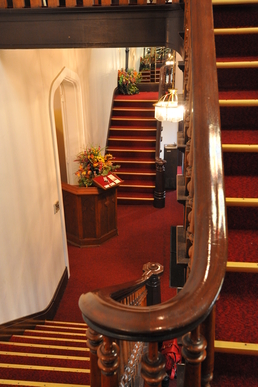 Double staircase in the foyer of Historic Indiana Wedding Venue, The Olde North Chapel, Richmond, Indiana