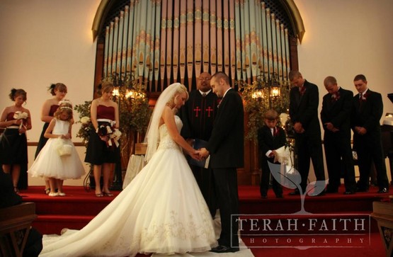 Historic Wedding chapel makes a perfect backdrop for this reverent moment during the ceremony, in Richmond, Indiana